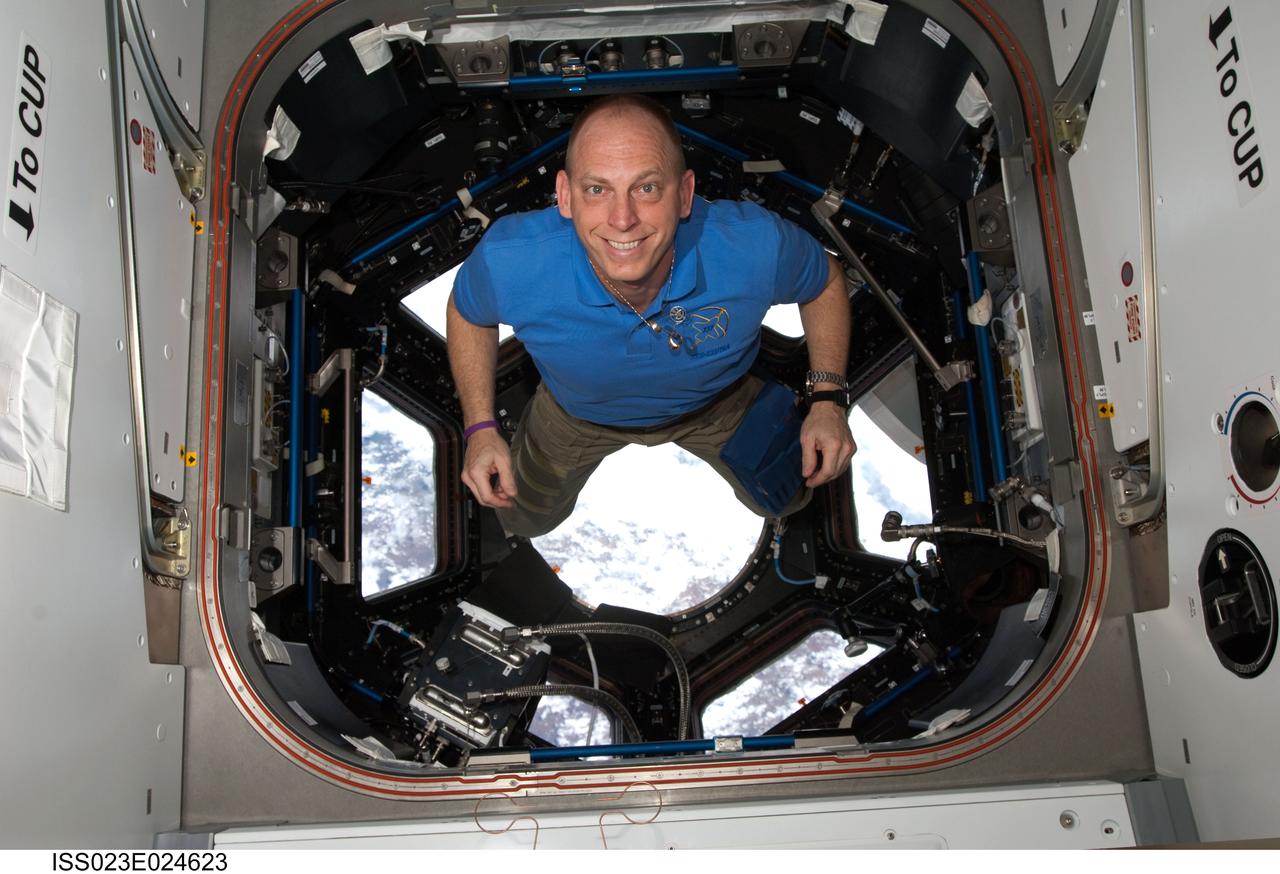 ISS023-E-024623 (17 April 2010) --- NASA astronaut Clayton Anderson, STS-131 mission specialist, poses for a photo in the Cupola of the International Space Station while space shuttle Discovery remains docked with the station.