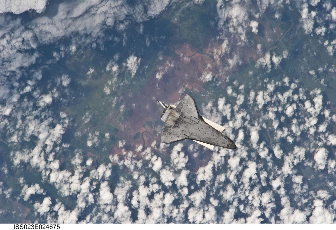 ISS023-E-024675 (17 April 2010) --- The space shuttle Discovery flies with its payload bay facing Earth so that the astronauts and cosmonauts onboard the International Space Station could survey and photograph it following the relative separation of the two spacecraft on April 17.