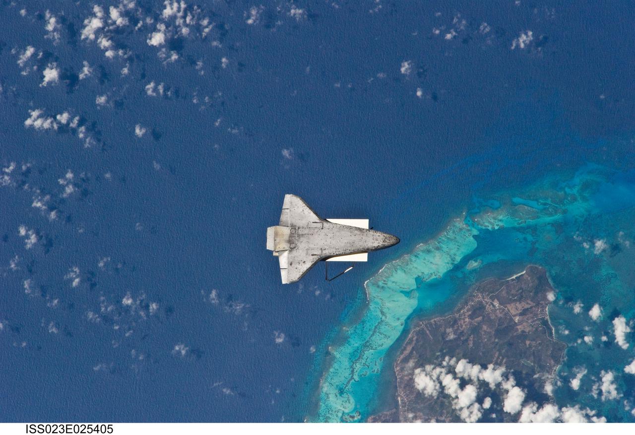 ISS023-E-025405 (17 April 2010) --- The underside of space shuttle Discovery is visible in this image photographed by an Expedition 23 crew member on the International Space Station soon after the shuttle and station began their post-undocking relative separation. Undocking of the two spacecraft occurred at 7:52 a.m. (CDT) on April 17, 2010, ending a stay of 10 days, 5 hours and 8 minutes. The visit included three spacewalks and delivery of more than seven tons of equipment and supplies. The recognizable feature on Earth below is the south end of Isla de Providencia, about 150 miles off the coast of Nicaragua near 13.3 degrees north latitude 81.4 degrees west longitude. The island belongs to Colombia.