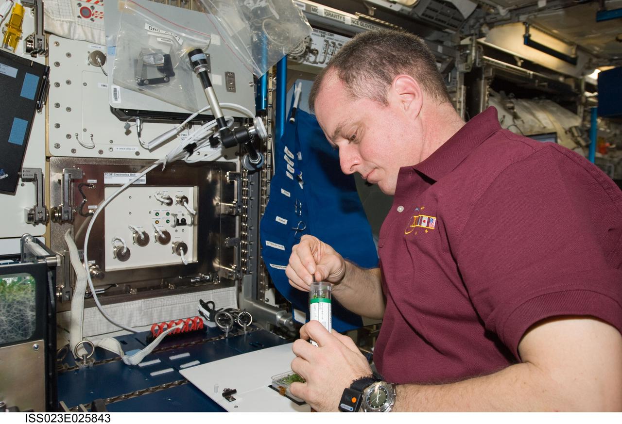 ISS023-E-025843 (21 April 2010) --- NASA astronaut T.J. Creamer, Expedition 23 flight engineer, services the Advanced Plant Experiments on Orbit-Cambium (APEX-Cambium) experiment in the Columbus laboratory of the International Space Station.