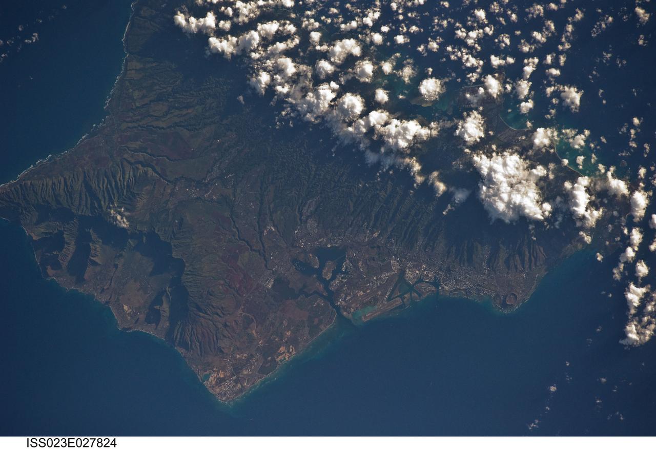 ISS023-E-027824 (23 April 2010) --- A member of the Expedition 23 crew onboard the Earth-orbiting International Space Station took this picture of Hawaii’s third largest island with an electronic still camera on April 23, 2010. Oahu is the commercial center of Hawaii, and tourism is the largest contributor to the economy. Among the many popular beaches is the renowned Waikiki Beach, backed by the famous Diamond Head, an extinct volcano. The largest community, Honolulu, is the state capital. Hickam Air Force Base is located on the island.