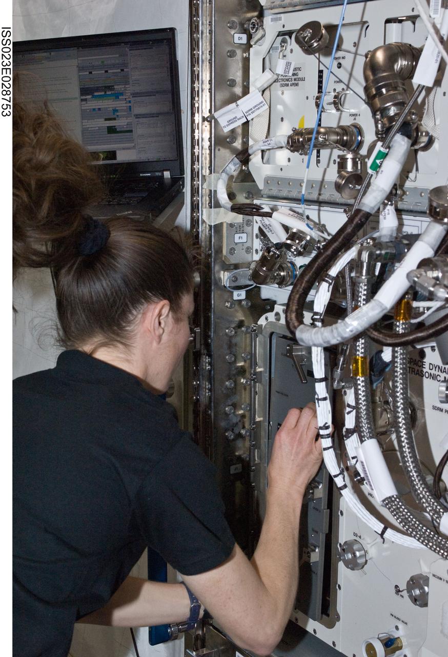 ISS023-E-028753 (28 April 2010) --- NASA astronaut Tracy Caldwell Dyson, Expedition 23 flight engineer, services the SpaceDRUMS/Space Dynamically Responding Ultrasonic Matrix (SDRM) hardware in the Kibo laboratory of the International Space Station.