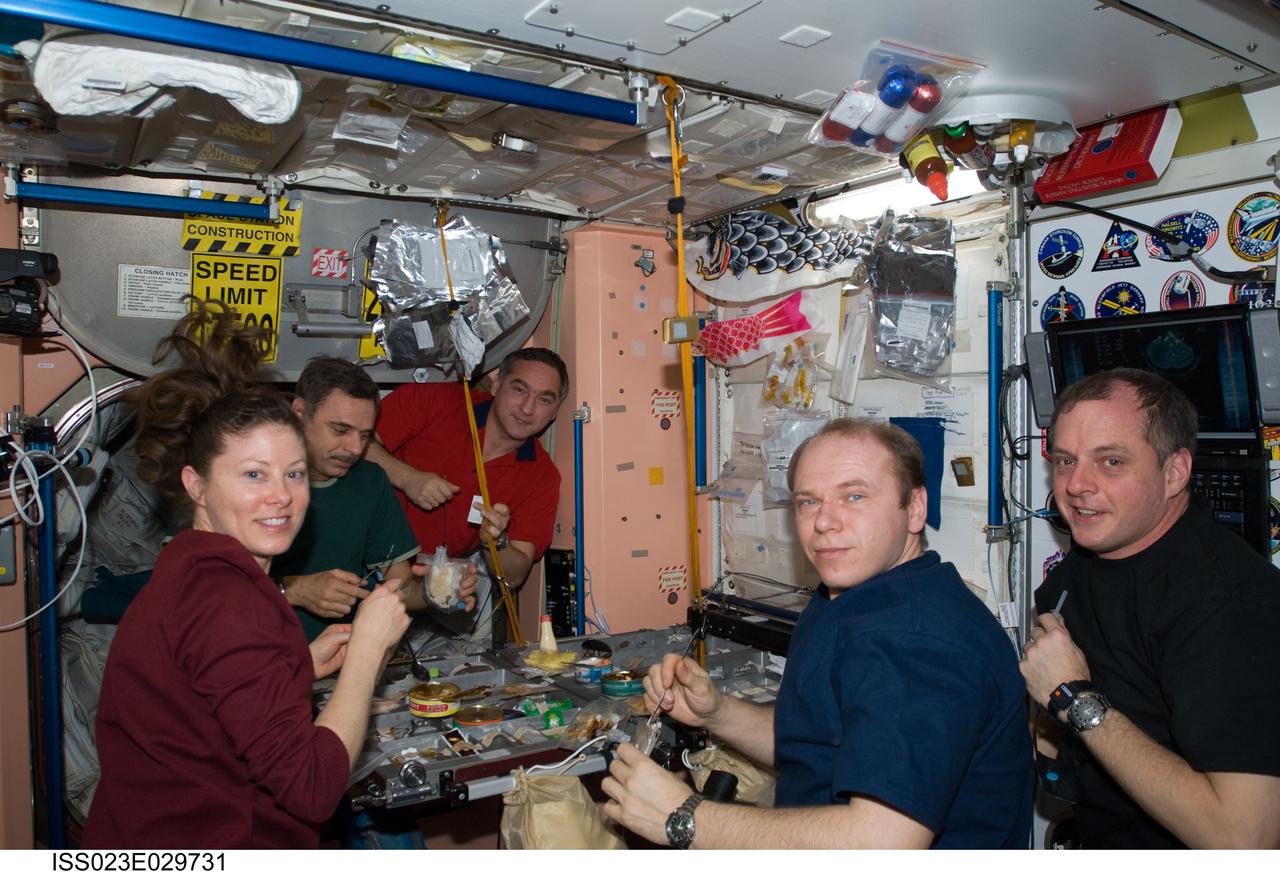 ISS023-E-029731 (29 April 2010) --- Expedition 23 crew members share a meal in the Unity node of the International Space Station. Pictured from the right are NASA astronaut T.J. Creamer, flight engineer; Russian cosmonaut Oleg Kotov, commander; NASA astronaut Tracy Caldwell Dyson, Russian cosmonauts Mikhail Kornienko and Alexander Skvortsov, all flight engineers.