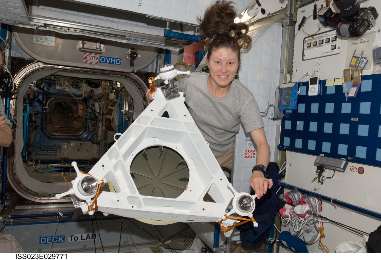 ISS023-E-029771 (1 May 2010) --- NASA astronaut Tracy Caldwell Dyson, Expedition 23 flight engineer, poses for a photo while holding Power and Data Grapple Fixture (PDGF) hardware in the Harmony node of the International Space Station.