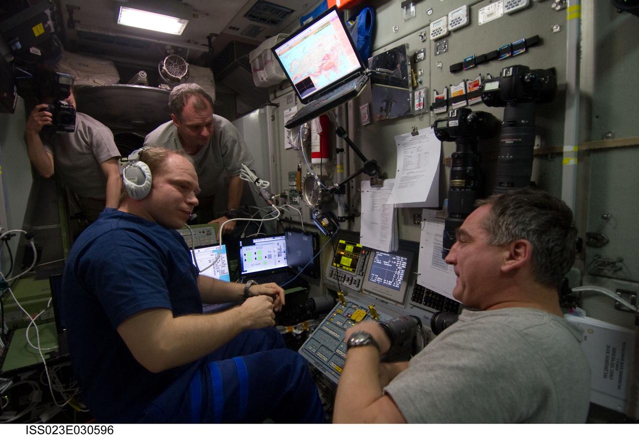 ISS023-E-030596 (1 May 2010) --- Russian cosmonaut Oleg Kotov (left foreground), Expedition 23 commander, is pictured at the manual TORU docking system controls in the Zvezda Service Module of the International Space Station shortly after conducting a manual control docking of the Progress 37 due to a jet failure on the Progress that forced a shutdown of the Kurs automated rendezvous system. Progress 37 docked to the Pirs Docking Compartment at 2:30 p.m. (EDT) on May 1, 2010, after a three-day flight from the Baikonur Cosmodrome in Kazakhstan. Also pictured are NASA astronauts Tracy Caldwell Dyson (left background) and T.J. Creamer; along with Russian cosmonaut Alexander Skvortsov (right foreground), all flight engineers.
