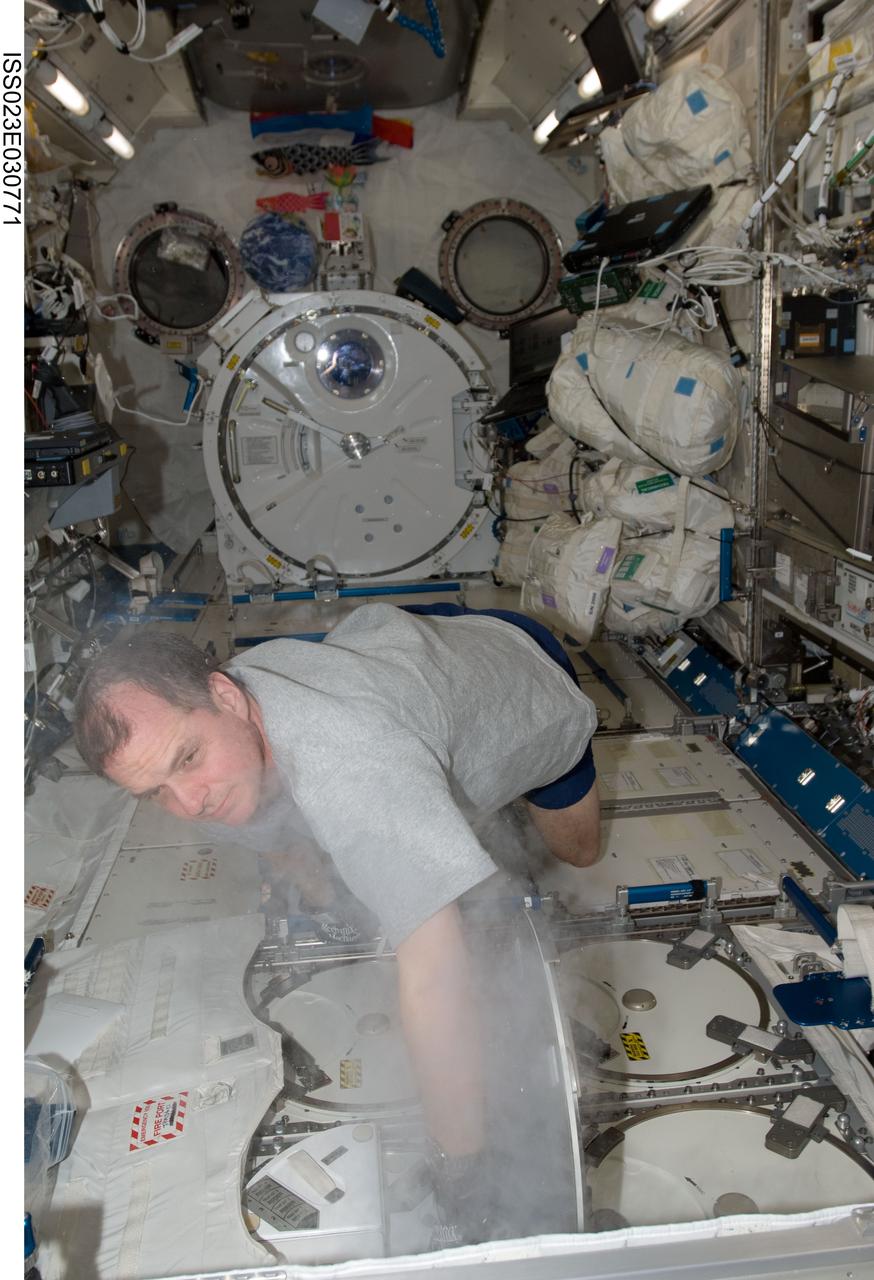 ISS023-E-030771 (2 May 2010) --- NASA astronaut T.J. Creamer, Expedition 23 flight engineer, services the Minus Eighty Laboratory Freezer for ISS (MELFI-1) in the Kibo laboratory of the International Space Station.