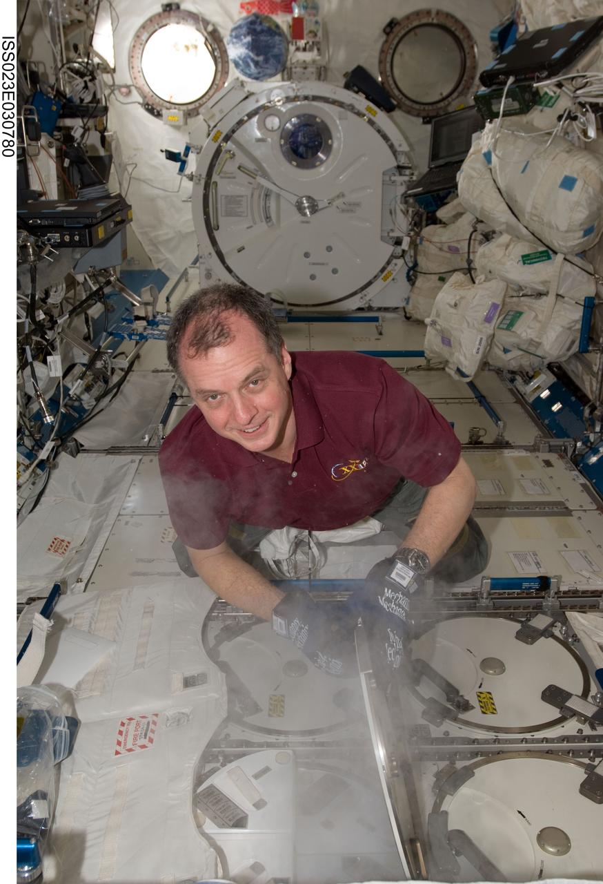 ISS023-E-030780 (2 May 2010) --- NASA astronaut T.J. Creamer, Expedition 23 flight engineer, services the Minus Eighty Laboratory Freezer for ISS (MELFI-1) in the Kibo laboratory of the International Space Station.
