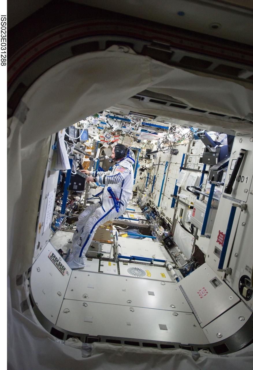 ISS023-E-031288 (3 May 2010) --- Attired in his Russian Sokol launch and entry suit, NASA astronaut T.J. Creamer, Expedition 23 flight engineer, works in the Destiny laboratory of the International Space Station.