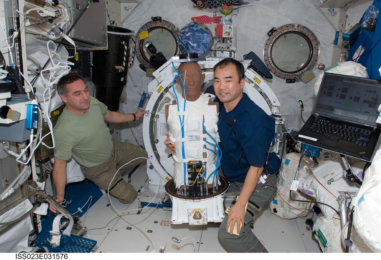 ISS023-E-031576 (4 May 2010) --- Russian cosmonaut Alexander Skvortsov (left) and Japan Aerospace Exploration Agency (JAXA) astronaut Soichi Noguchi, both Expedition 23 flight engineers, work with the European Matroshka-R Phantom experiment in the Kibo laboratory of the International Space Station. Matroshka, the name for the traditional Russian set of nestling dolls, is an antroph-amorphous model of a human torso designed for radiation studies.