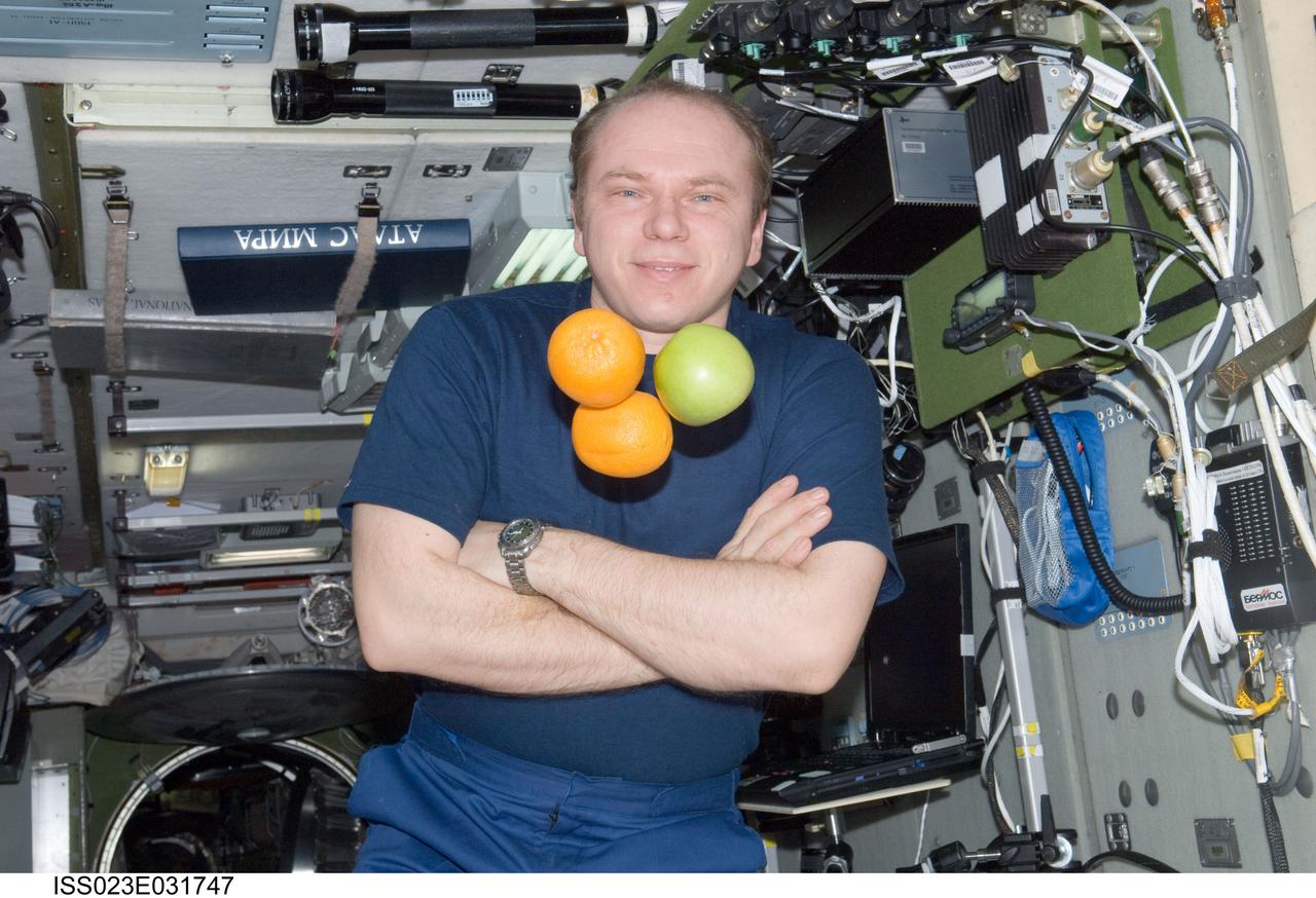 ISS023-E-031747 (1 May 2010) --- Russian cosmonaut Oleg Kotov, Expedition 23 commander, is pictured near fresh fruit floating freely in the Zvezda Service Module of the International Space Station.