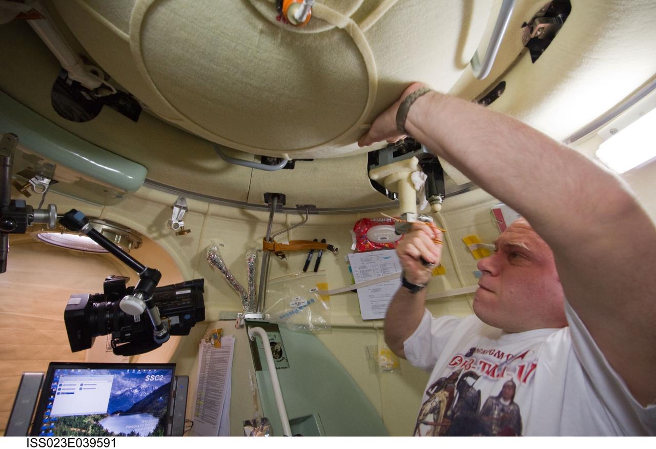 ISS023-E-039591 (12 May 2010) --- Russian cosmonaut Oleg Kotov, Expedition 23 commander, is pictured in the Soyuz 21 (TMA-17) spacecraft during preparations for its relocation from the Zarya nadir port to the Zvezda Service Module's aft port on May 12, 2010.