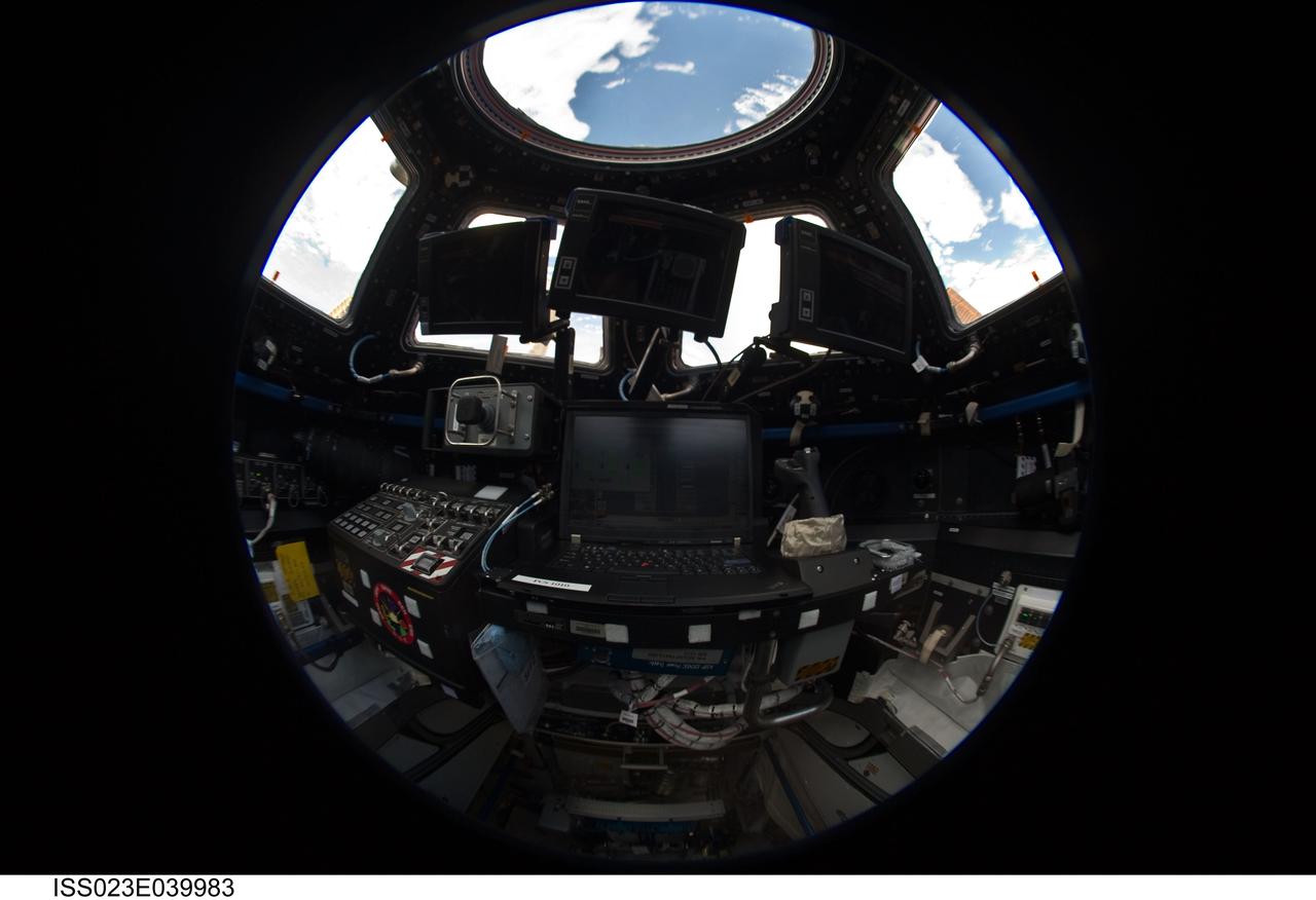 ISS023-E-039983 (8 May 2010) --- A fish-eye lens attached to an electronic still camera was used by an Expedition 23 crew member to capture this image of the robotic workstation in the Cupola of the International Space Station.
