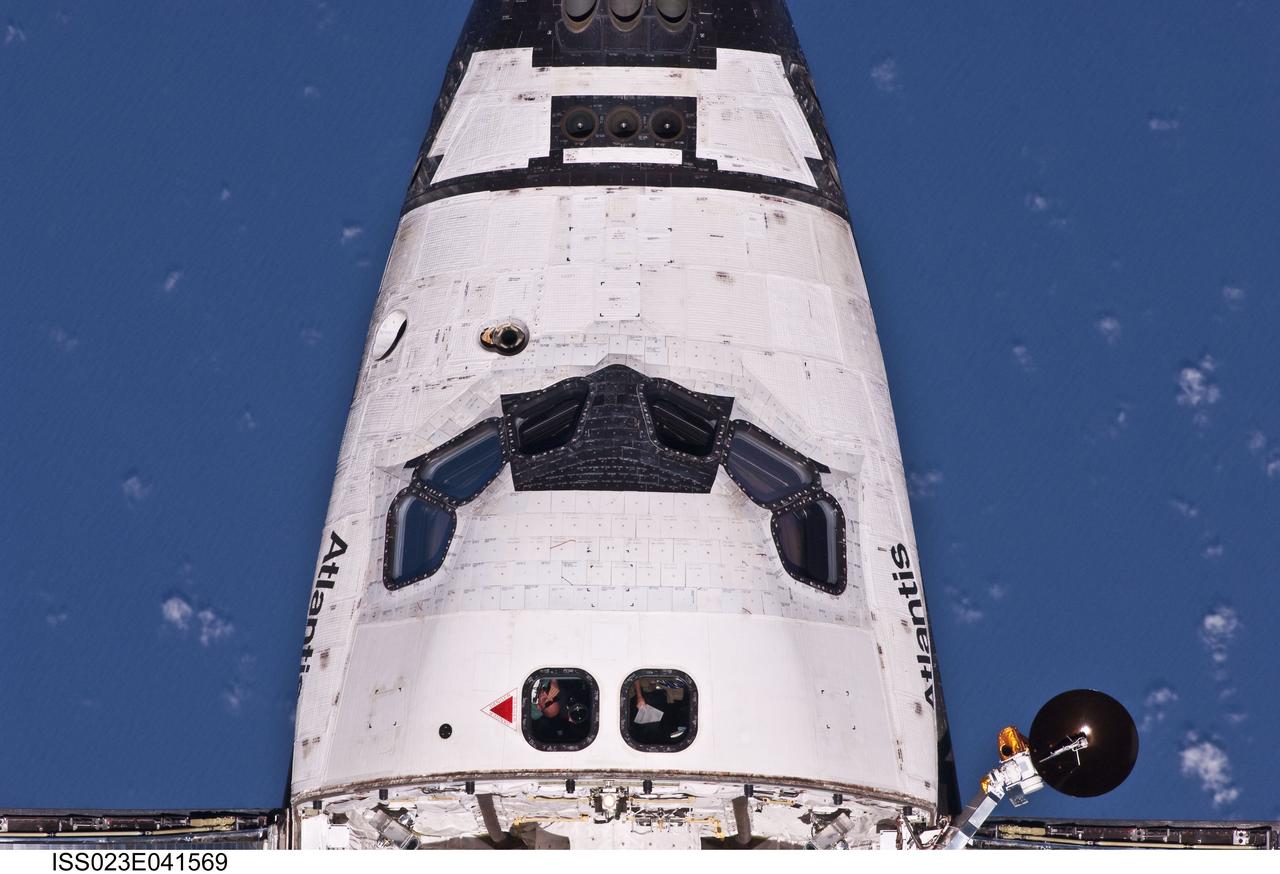 ISS023-E-041569 (16 May 2010) --- This view of crew cabin of the space shuttle Atlantis was provided by an Expedition 23 crew member during a survey of the approaching STS-132 vehicle prior to docking with the International Space Station. As part of the survey and part of every mission's activities, Atlantis performed a back-flip for the rendezvous pitch maneuver (RPM). The image was photographed with a digital still camera, using a 400mm lens at a distance of about 600 feet (180 meters).