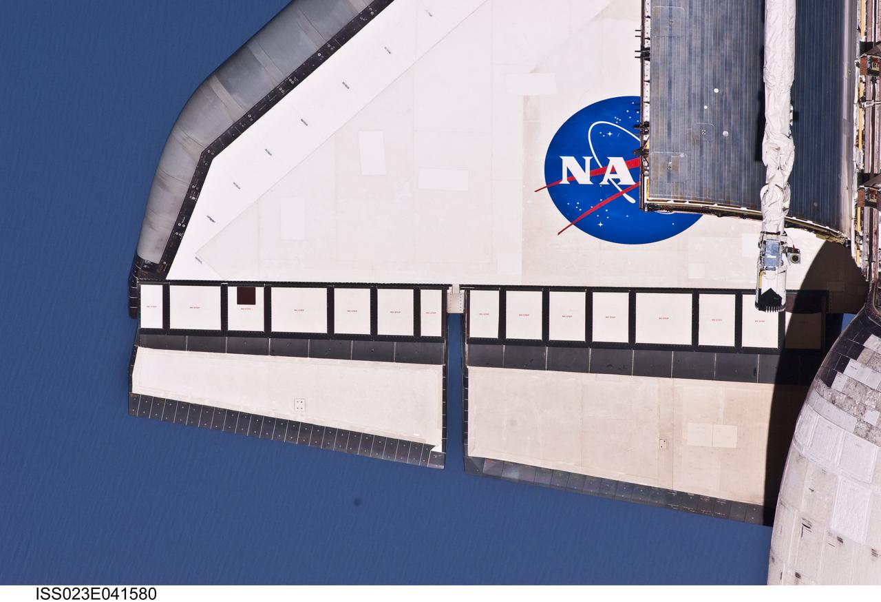 ISS023-E-041580 (16 May 2010) --- This partial view of the port wing of the space shuttle Atlantis was provided by an Expedition 23 crew member during a survey of the approaching STS-132 vehicle prior to docking with the International Space Station. As part of the survey and part of every mission's activities, Atlantis performed a back-flip for the rendezvous pitch maneuver (RPM). The image was photographed with a digital still camera, using a 400mm lens at a distance of about 600 feet (180 meters).