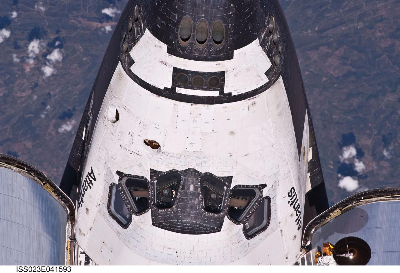 ISS023-E-041593 (16 May 2010) --- This view of crew cabin of the space shuttle Atlantis was provided by an Expedition 23 crew member during a survey of the approaching STS-132 vehicle prior to docking with the International Space Station. As part of the survey and part of every mission's activities, Atlantis performed a back-flip for the rendezvous pitch maneuver (RPM). The image was photographed with a digital still camera, using a 400mm lens at a distance of about 600 feet (180 meters).