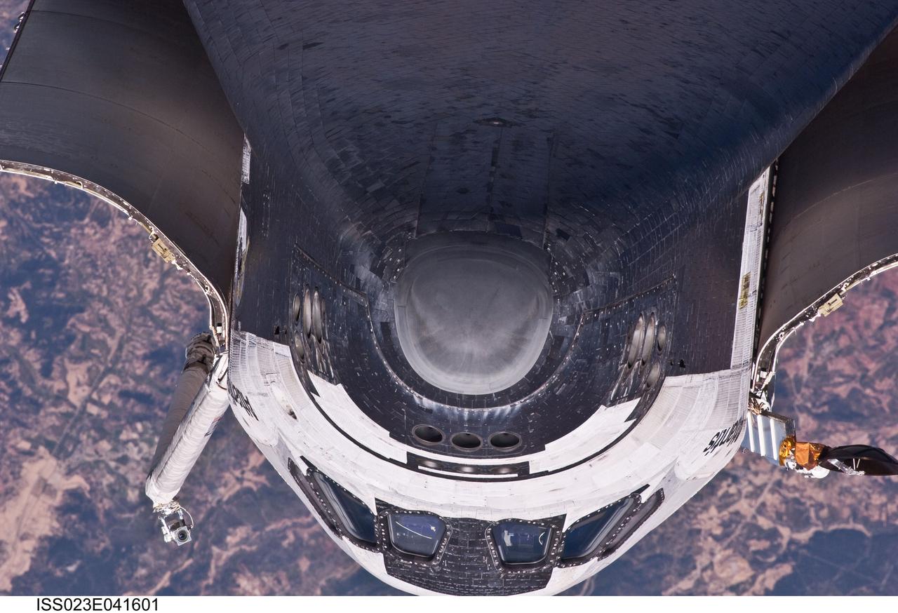ISS023-E-041601 (16 May 2010) --- This view of the underside of the crew cabin of the space shuttle Atlantis was provided by an Expedition 23 crew member during a survey of the approaching STS-132 vehicle prior to docking with the International Space Station. As part of the survey and part of every mission's activities, Atlantis performed a back-flip for the rendezvous pitch maneuver (RPM). The image was photographed with a digital still camera, using a 400mm lens at a distance of about 600 feet (180 meters).
