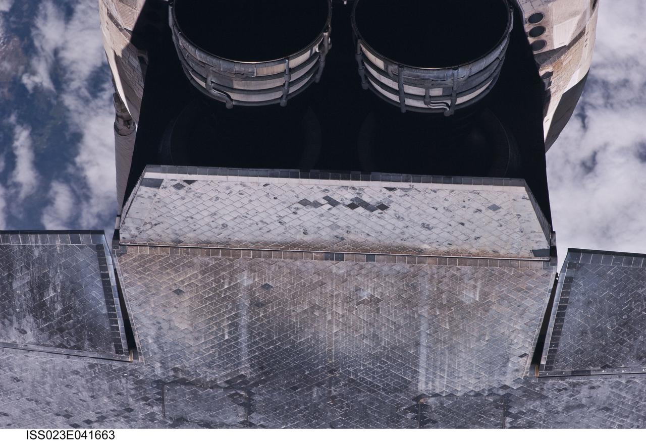 ISS023-E-041663 (16 May 2010) --- This view of the underside of the space shuttle Atlantis was provided by an Expedition 23 crew member during a survey of the approaching STS-132 vehicle prior to docking with the International Space Station. As part of the survey and part of every mission's activities, Atlantis performed a back-flip for the rendezvous pitch maneuver (RPM). The image was photographed with a digital still camera, using a 400mm lens at a distance of about 600 feet (180 meters).