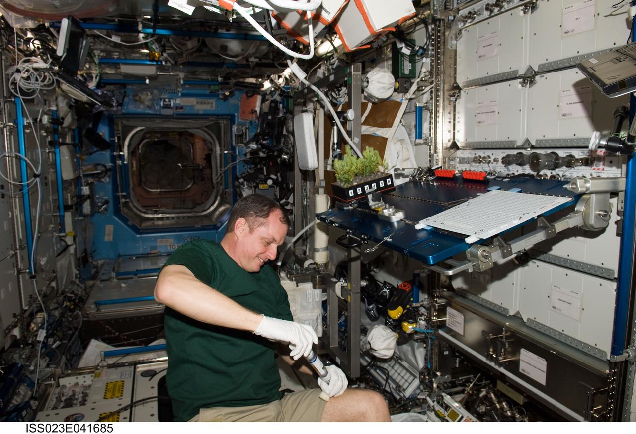 ISS023-E-041685 (10 May 2010) --- NASA astronaut T.J. Creamer, Expedition 23 flight engineer, services the Advanced Plant Experiments on Orbit-Cambium (APEX-Cambium) experiment in the Destiny laboratory of the International Space Station.