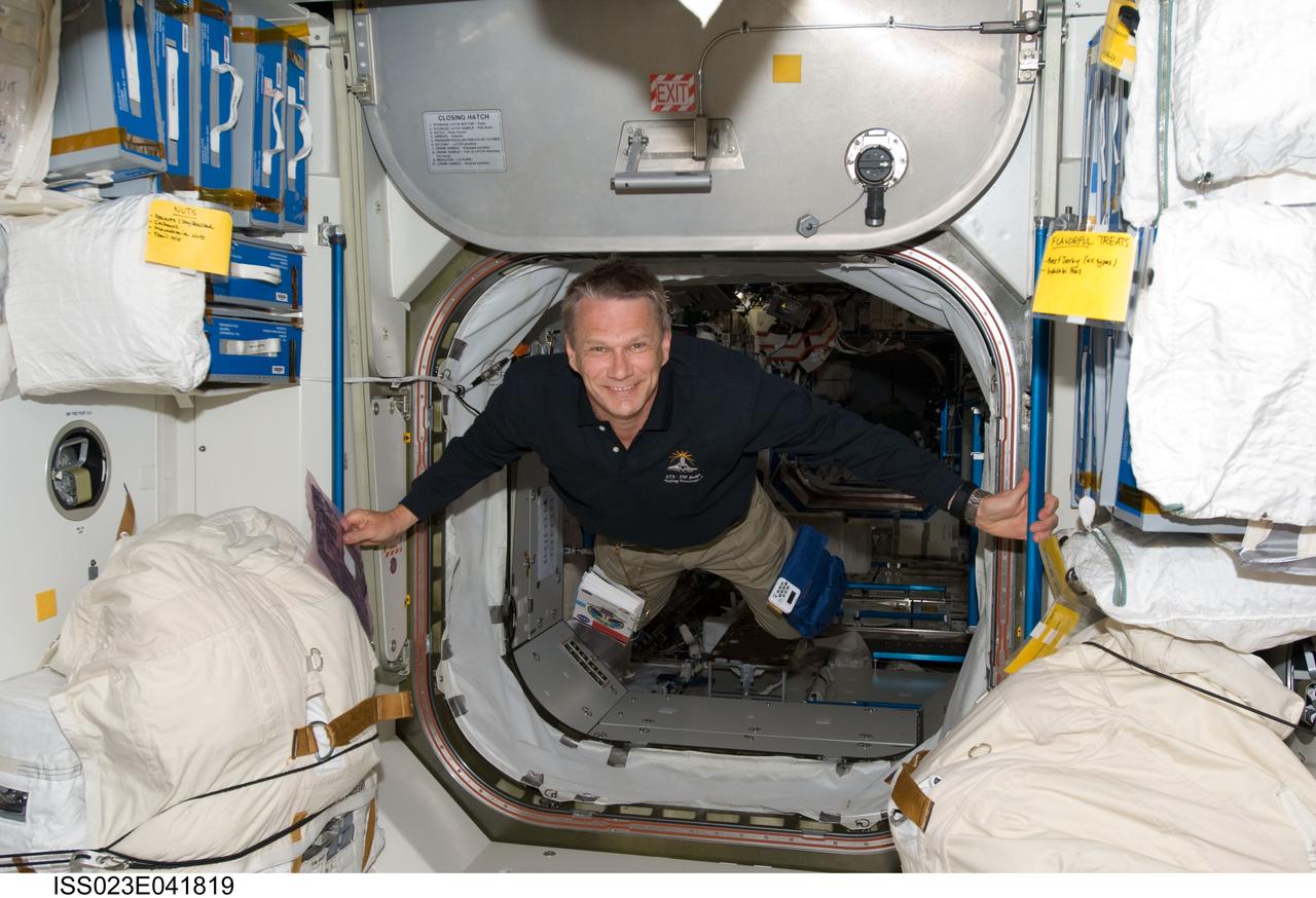 ISS023-E-041819 (16 May 2010) --- NASA astronaut Piers Sellers, STS-132 mission specialist, floats through a hatch on the International Space Station while space shuttle Atlantis remains docked with the station.