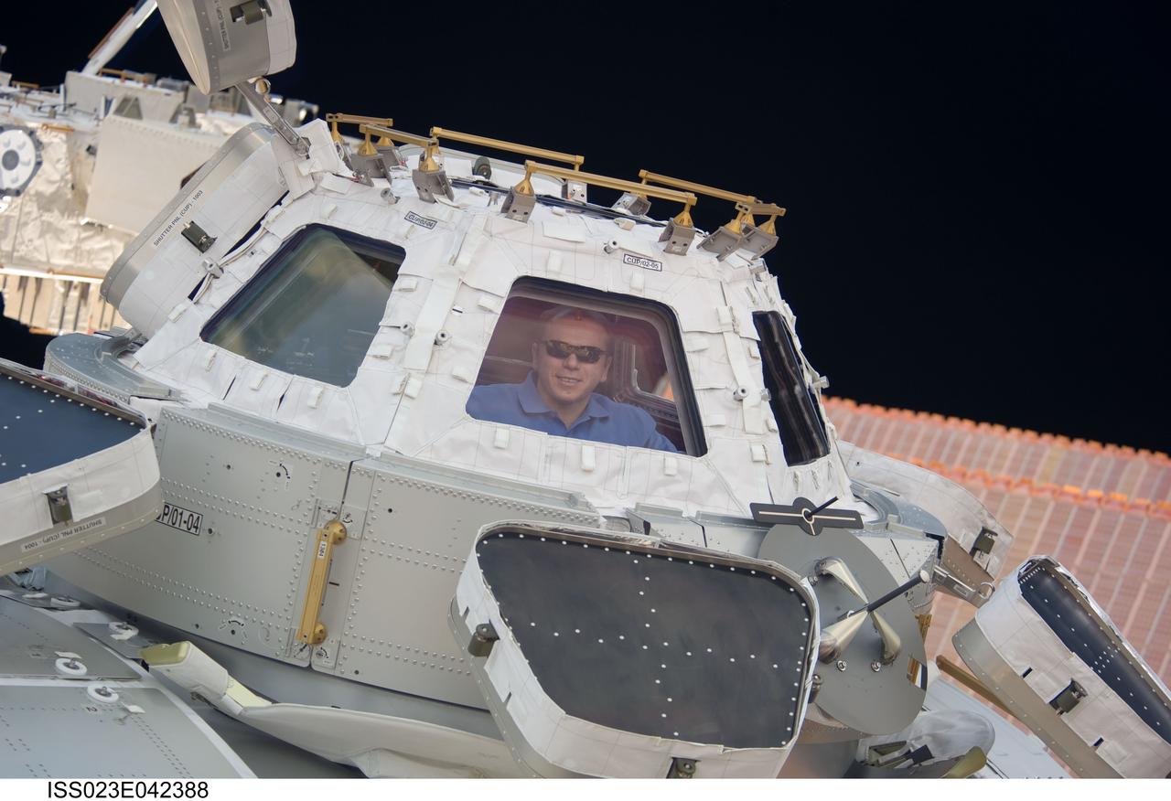 ISS023-E-042388 (10 May 2010) --- Russian cosmonaut Oleg Kotov, Expedition 23 commander, is pictured in a window of the Cupola of the International Space Station.