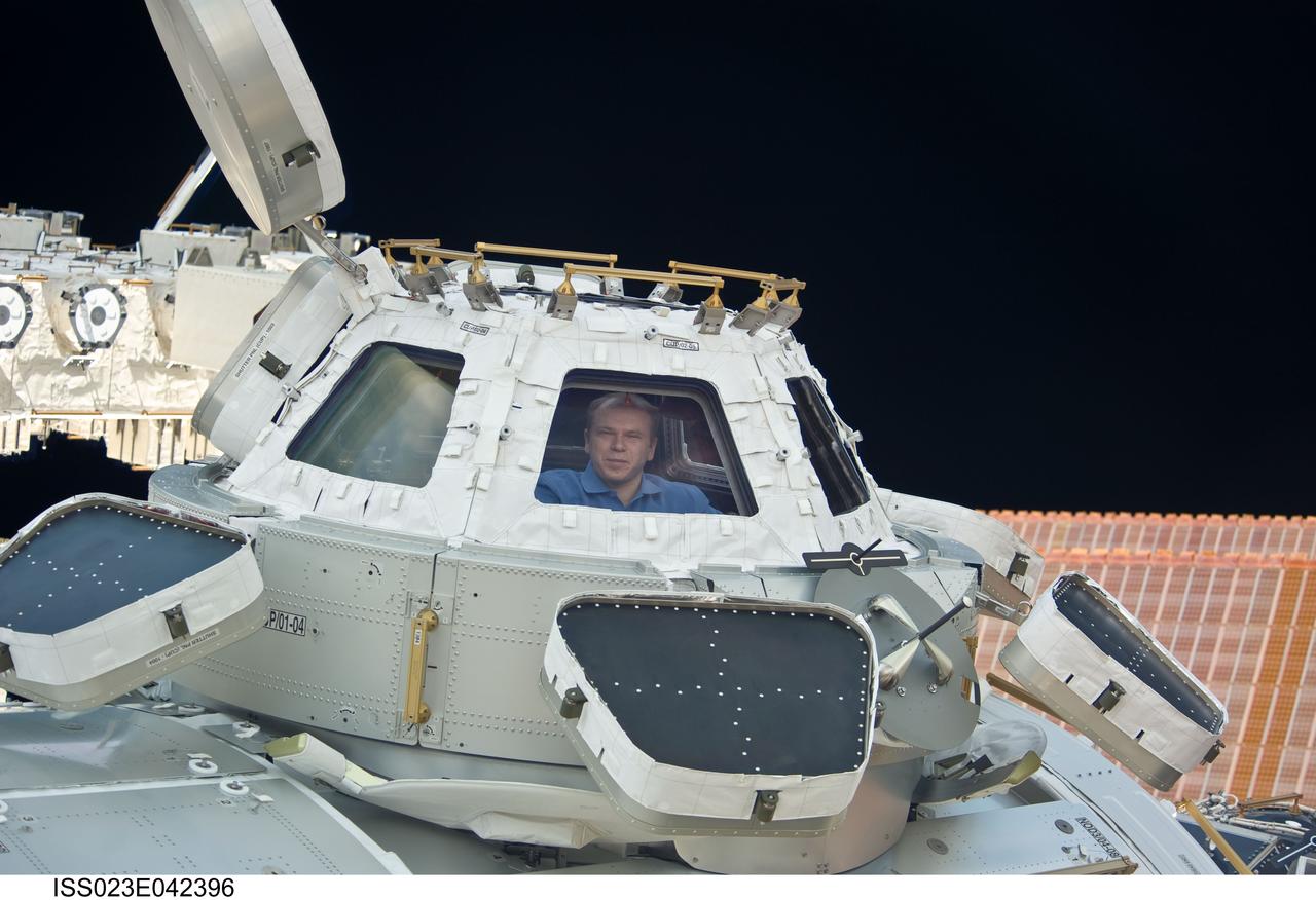ISS023-E-042396 (10 May 2010) --- Russian cosmonaut Oleg Kotov, Expedition 23 commander, is pictured in a window of the Cupola of the International Space Station.