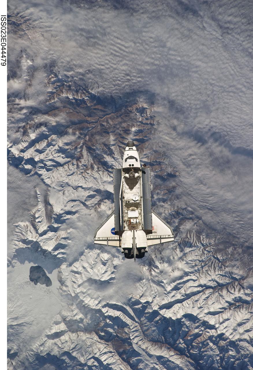 ISS023-E-044479 (16 May 2010) ?-- Backdropped against the Andes Mountains near the border of Argentina and Chile, the space shuttle Atlantis is shown making its relative approach to the International Space Station, from which this photo was taken. Center point coordinates are 34.2 south latitude and 69.5 degrees west longitude. Laguna del Diamante is the lagoon seen in the lower left of the photo. Photo credit: NASA or National Aeronautics and Space Administration