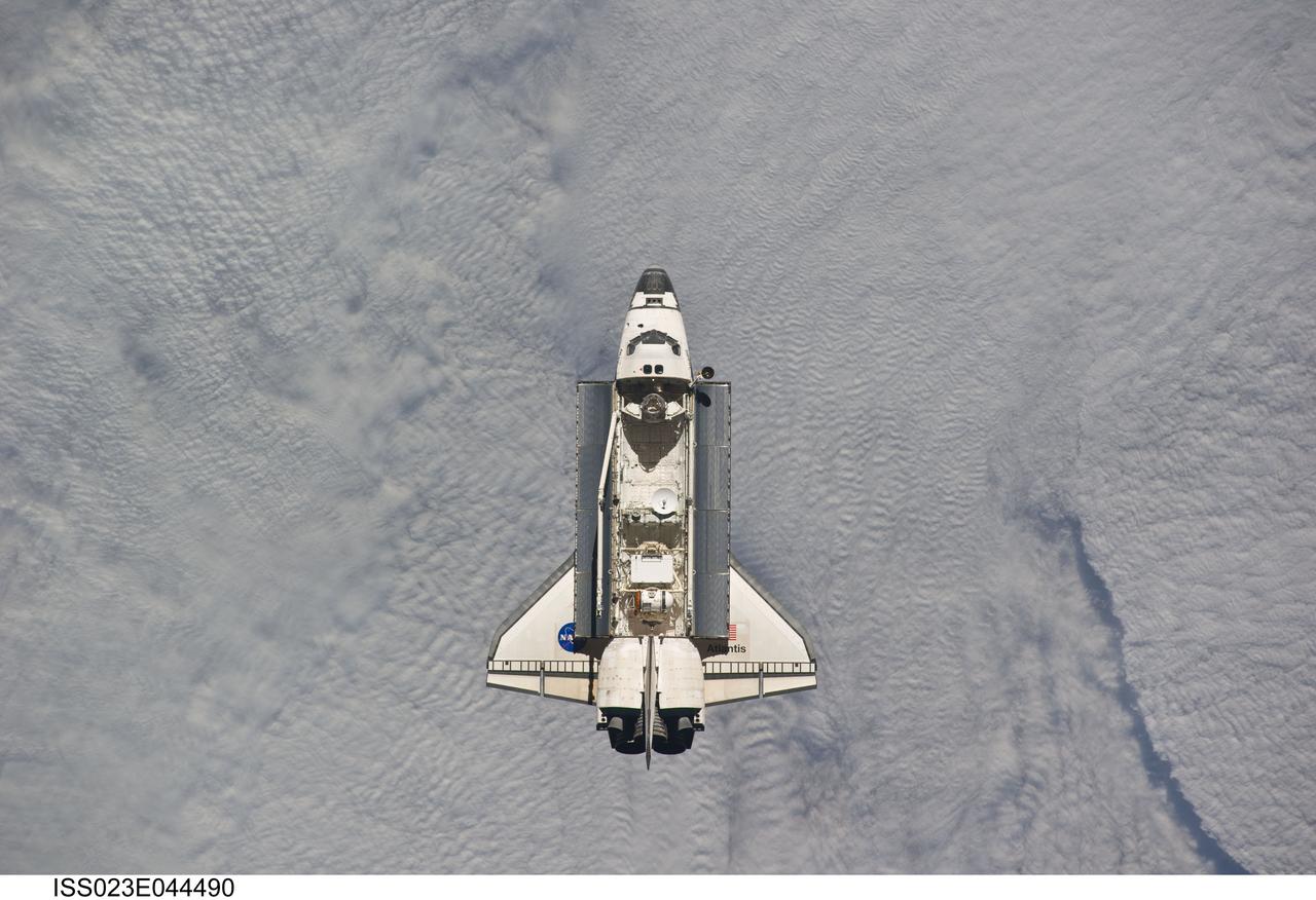 ISS023-E-044490 (16 May 2010) --- Backdropped by a blanket of clouds, space shuttle Atlantis is featured in this image photographed by an Expedition 23 crew member as the shuttle approaches the International Space Station during STS-132 rendezvous and docking operations. Docking occurred at 9:28 a.m. (CDT) on May 16, 2010.