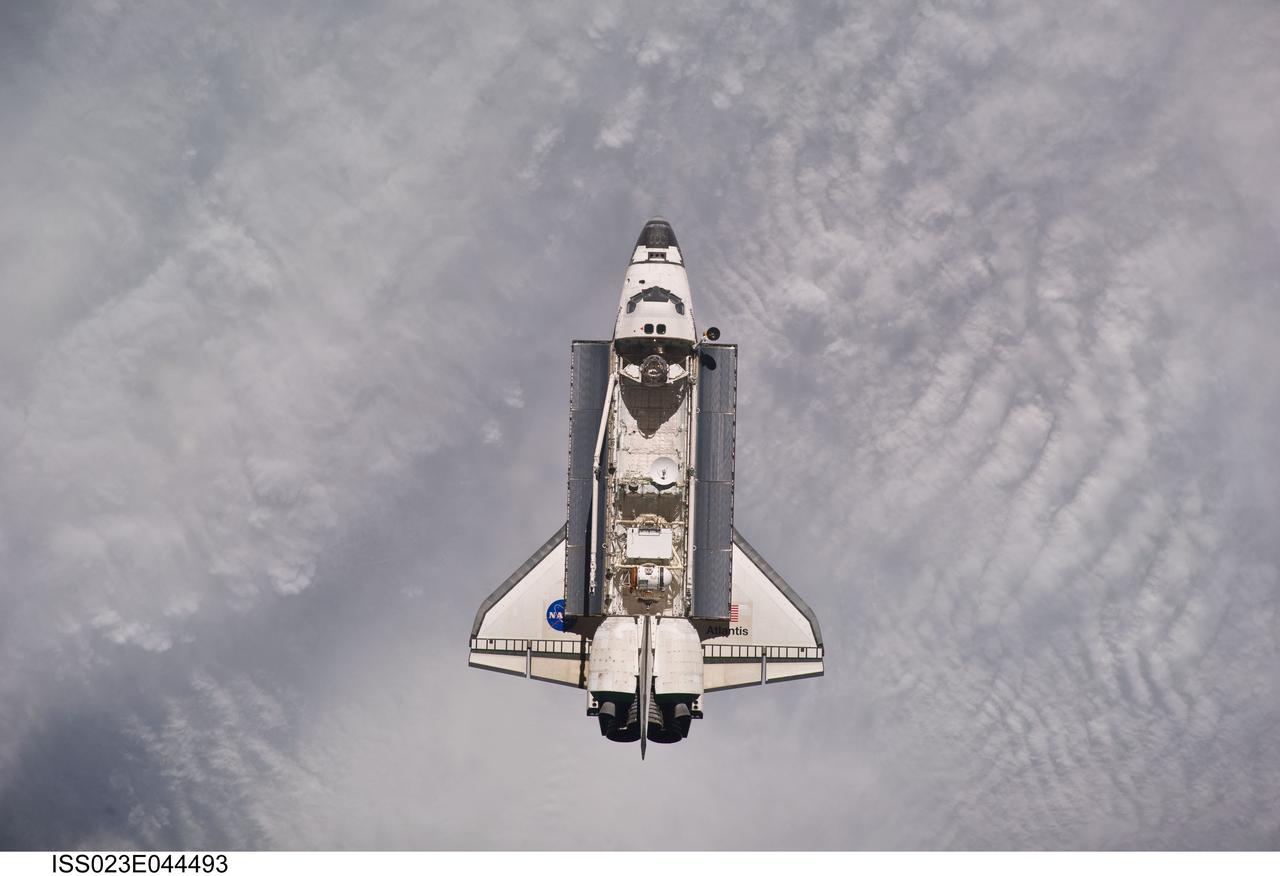 ISS023-E-044493 (16 May 2010) --- Backdropped by a blanket of clouds, space shuttle Atlantis is featured in this image photographed by an Expedition 23 crew member as the shuttle approaches the International Space Station during STS-132 rendezvous and docking operations. Docking occurred at 9:28 a.m. (CDT) on May 16, 2010.