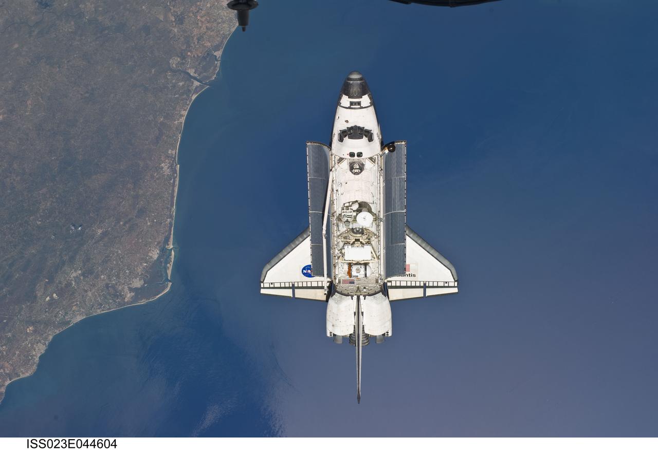 ISS023-E-044604 (16 May 2010) --- Backdropped by a colorful Earth, space shuttle Atlantis is featured in this image photographed by an Expedition 23 crew member as the shuttle approaches the International Space Station during STS-132 rendezvous and docking operations. Docking occurred at 9:28 a.m. (CDT) on May 16, 2010.