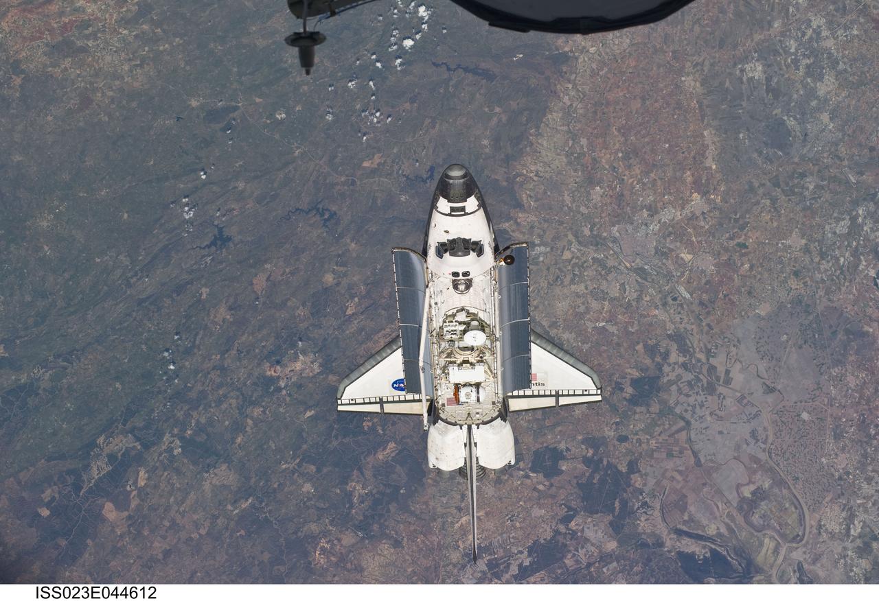 ISS023-E-044612 (16 May 2010) --- Backdropped by a colorful Earth, space shuttle Atlantis is featured in this image photographed by an Expedition 23 crew member as the shuttle approaches the International Space Station during STS-132 rendezvous and docking operations. Docking occurred at 9:28 a.m. (CDT) on May 16, 2010.