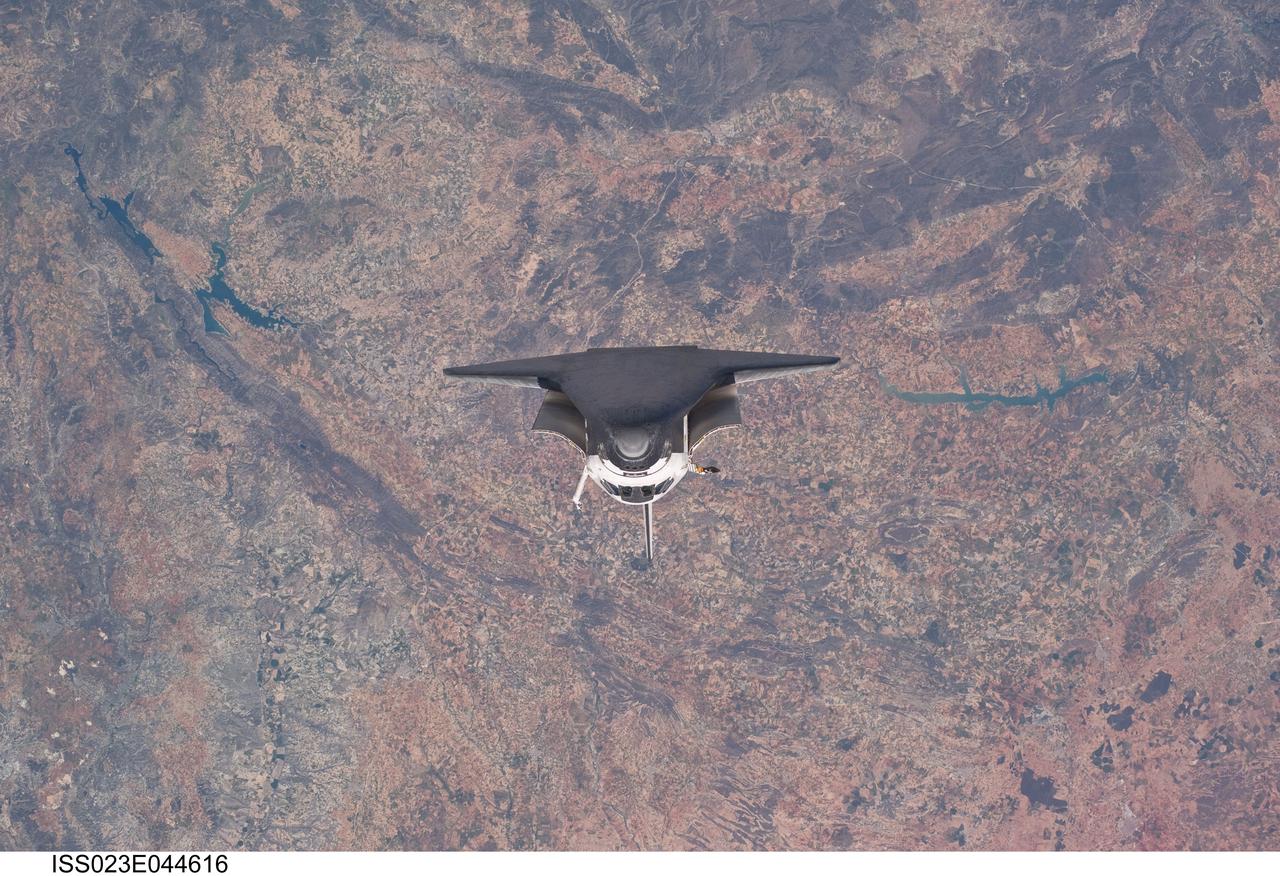 ISS023-E-044616 (16 May 2010) --- Backdropped by a colorful Earth, space shuttle Atlantis is featured in this image photographed by an Expedition 23 crew member as the shuttle approaches the International Space Station during STS-132 rendezvous and docking operations. Docking occurred at 9:28 a.m. (CDT) on May 16, 2010.