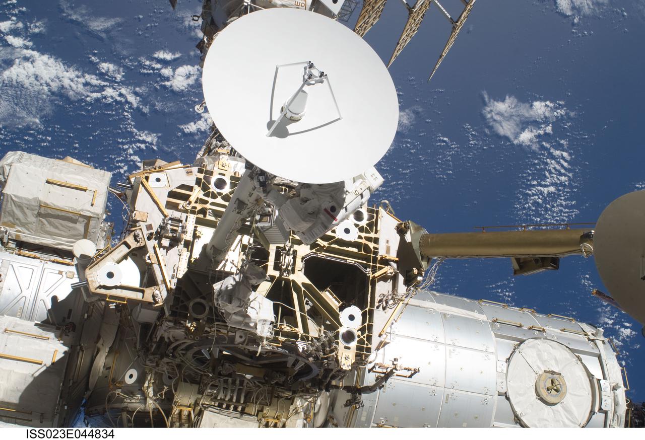 ISS023-E-044834 (17 May 2010) --- NASA astronaut Steve Bowen (partially obscured by Ku-band antenna), STS-132 mission specialist, participates in the mission's first session of extravehicular activity (EVA) as construction and maintenance continue on the International Space Station. During the seven-hour, 25-minute spacewalk, Bowen and NASA astronaut Garrett Reisman (out of frame), mission specialist, loosened bolts holding six replacement batteries, installed a second antenna for high-speed Ku-band transmissions and adding a spare parts platform to Dextre, a two-armed extension for the station?s robotic arm.