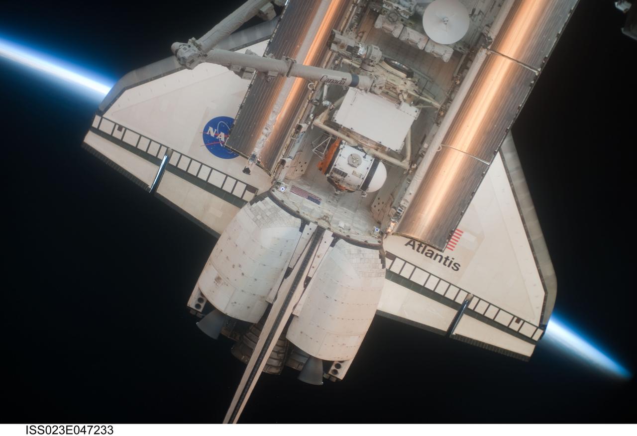 ISS023-E-047233 (16 May 2010) --- Intersecting the thin line of Earth's atmosphere, the aft section of space shuttle Atlantis is featured in this image photographed by an Expedition 23 crew member shortly after Atlantis docked with the International Space Station. The Russian-built Mini-Research Module 1 (MRM-1), named Rassvet, is visible in the cargo bay.