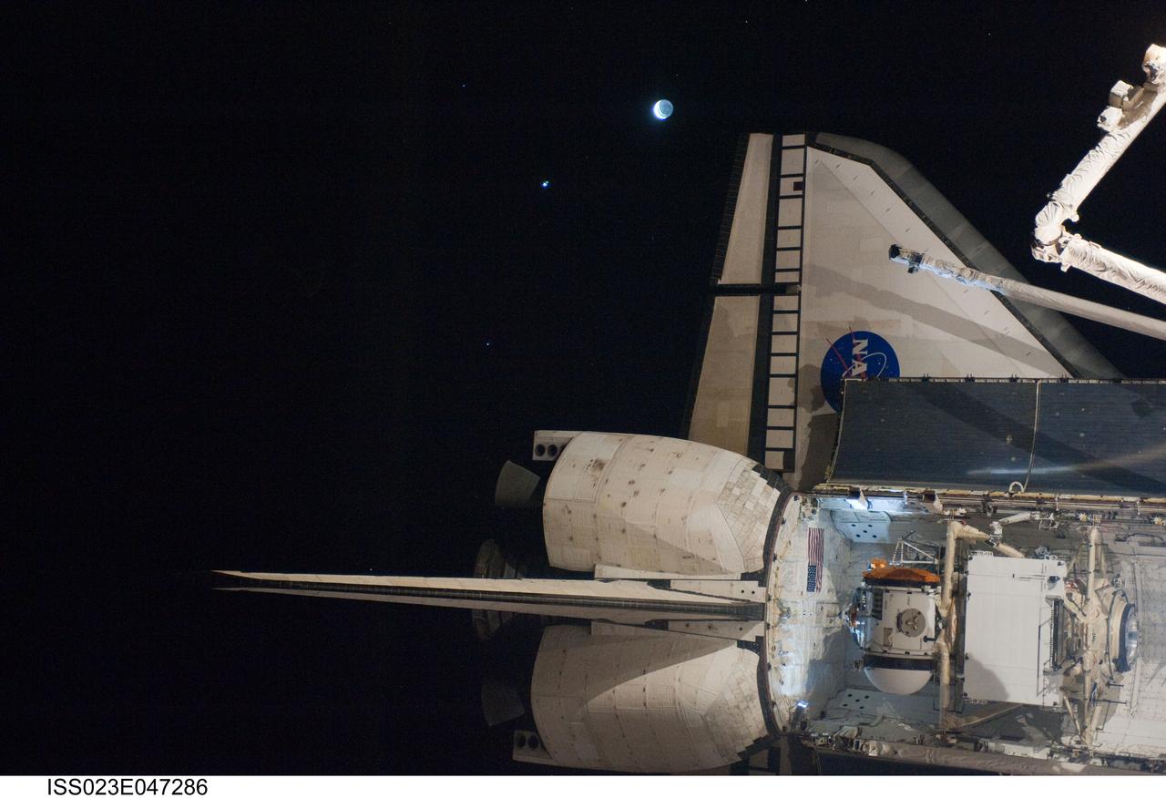 ISS023-E-047286 (16 May 2010) --- The aft section of space shuttle Atlantis is featured in this image photographed by an Expedition 23 crew member shortly after Atlantis docked with the International Space Station. The Russian-built Mini-Research Module 1 (MRM-1), named Rassvet, is visible in the cargo bay. The planet Venus and the moon are visible at top center.