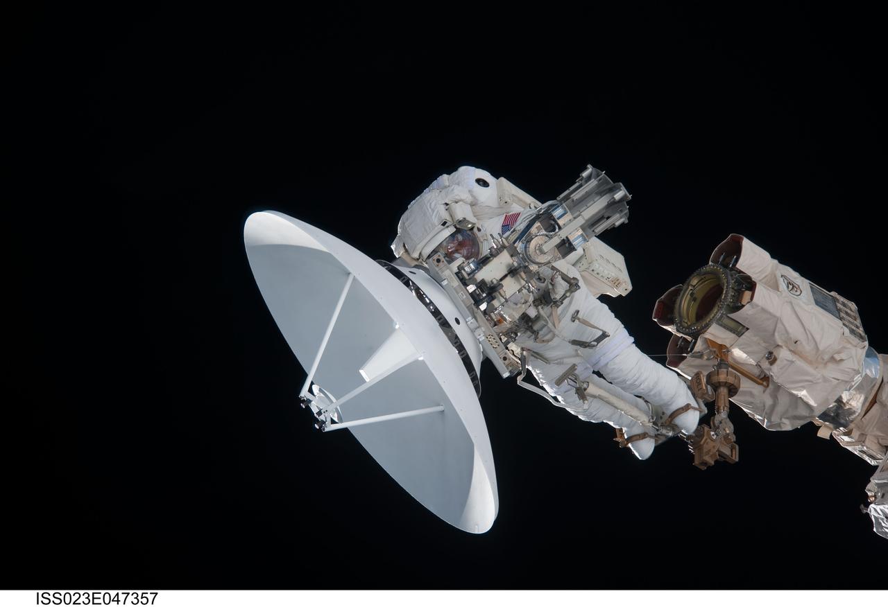 ISS023-E-047357 (17 May 2010) --- Anchored to a Canadarm2 mobile foot restraint, NASA astronaut Garrett Reisman, STS-132 mission specialist, participates in the mission's first session of extravehicular activity (EVA) as construction and maintenance continue on the International Space Station. During the seven-hour, 25-minute spacewalk, Reisman and NASA astronaut Steve Bowen (out of frame), mission specialist, loosened bolts holding six replacement batteries, installed a second antenna for high-speed Ku-band transmissions and adding a spare parts platform to Dextre, a two-armed extension for the station?s robotic arm.