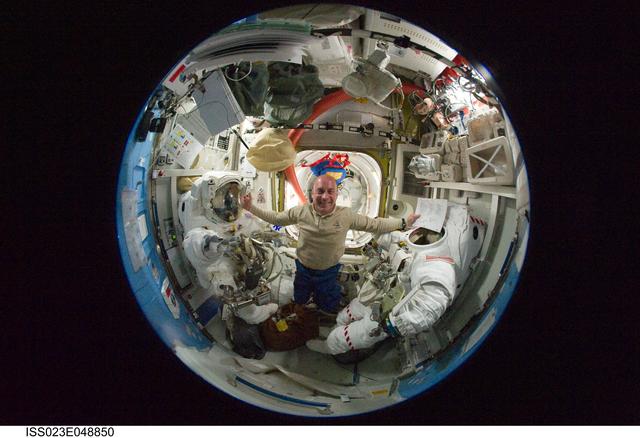 NASA image: Fisheye view of Reisman in A/L during EVA 3 Preparations