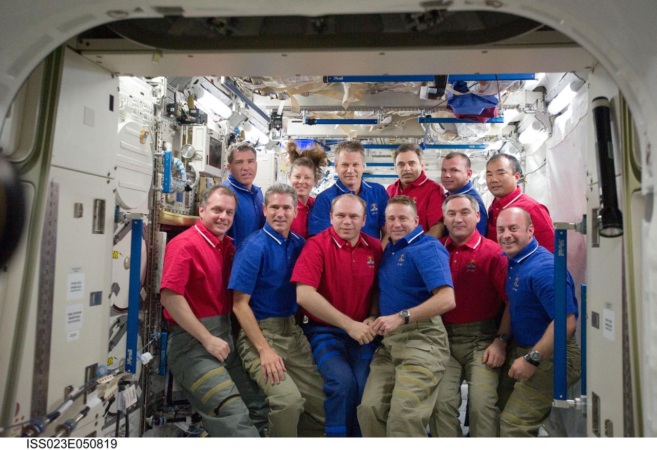 ISS023-E-050819 (23 May 2010) --- STS-132 (blue shirts) and Expedition 23 crew members pose for a group portrait on the International Space Station while space shuttle Atlantis remains docked with the station. Pictured on the front row are Russian cosmonaut Oleg Kotov (center left), Expedition 23 commander; and NASA astronaut Ken Ham (center right), STS-132 commander; along with (from the left) NASA astronauts T.J. Creamer, Expedition 23 flight engineer; Michael Good, STS-132 mission specialist; Russian cosmonaut Alexander Skvortsov, Expedition 23 flight engineer; and NASA astronaut Garrett Reisman, STS-132 mission specialist. Pictured on the back row (from the left) are NASA astronauts Steve Bowen, STS-132 mission specialist; Tracy Caldwell Dyson, Expedition 23 flight engineer; Piers Sellers, STS-132 mission specialist; Russian cosmonaut Mikhail Kornienko, Expedition 23 flight engineer; NASA astronaut Tony Antonelli, STS-132 pilot; and Japan Aerospace Exploration Agency (JAXA) astronaut Soichi Noguchi, Expedition 23 flight engineer.
