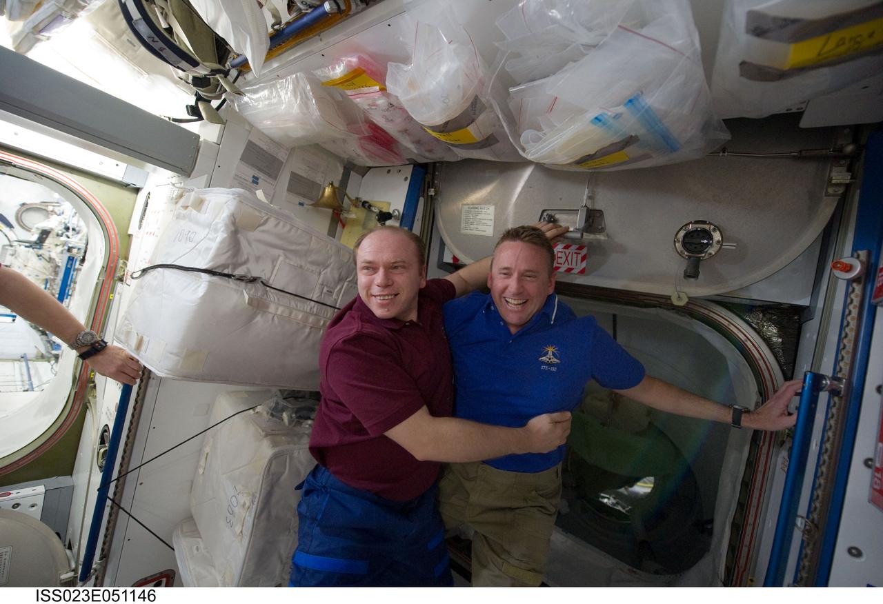 ISS023-E-051146 (23 May 2010) --- Russian cosmonaut Oleg Kotov (left), Expedition 23 commander; and NASA astronaut Ken Ham, STS-132 commander, are pictured during a farewell ceremony in the Harmony node of the International Space Station while space shuttle Atlantis remains docked with the station.