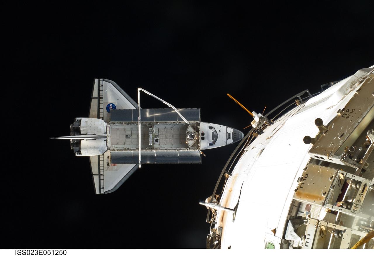 ISS023-E-051250 (23 May 2010) --- Space shuttle Atlantis is featured in this image photographed by an Expedition 23 crew member on the International Space Station soon after the shuttle and station began their post-undocking relative separation. Undocking of the two spacecraft occurred at 10:22 a.m. (CDT) on May 23, 2010, ending a seven-day stay that saw the addition of a new station module, replacement of batteries and resupply of the orbiting outpost. A portion of a docked Russian spacecraft is visible at right.