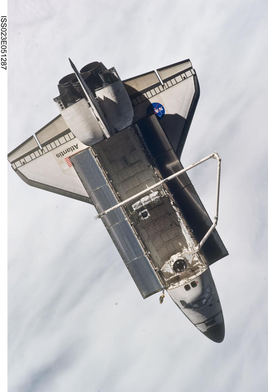 ISS023-E-051287 (23 May 2010) --- Space shuttle Atlantis is featured in this image photographed by an Expedition 23 crew member on the International Space Station soon after the shuttle and station began their post-undocking relative separation. Undocking of the two spacecraft occurred at 10:22 a.m. (CDT) on May 23, 2010, ending a seven-day stay that saw the addition of a new station module, replacement of batteries and resupply of the orbiting outpost. A blanket of clouds provides the backdrop for the scene.
