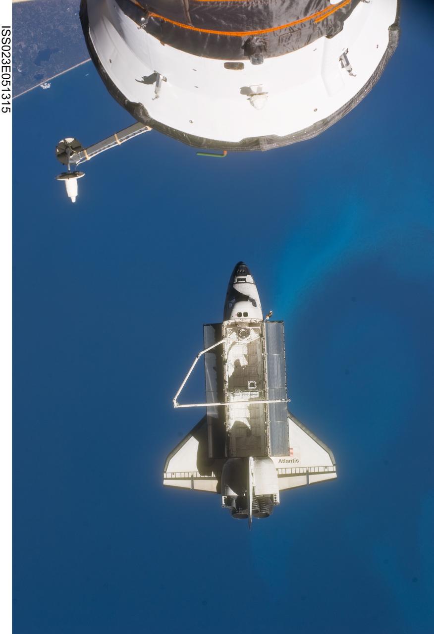 ISS023-E-051315 (23 May 2010) --- Space shuttle Atlantis is featured in this image photographed by an Expedition 23 crew member on the International Space Station soon after the shuttle and station began their post-undocking relative separation. Undocking of the two spacecraft occurred at 10:22 a.m. (CDT) on May 23, 2010, ending a seven-day stay that saw the addition of a new station module, replacement of batteries and resupply of the orbiting outpost. A portion of a Russian spacecraft docked to the station is at top. A blue part of Earth provides the backdrop for the scene.