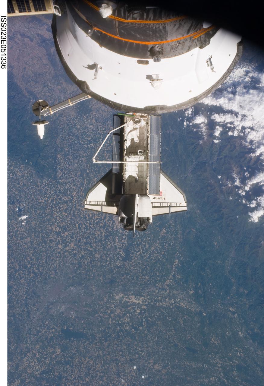ISS023-E-051336 (23 May 2010) --- Space shuttle Atlantis is featured in this image photographed by an Expedition 23 crew member on the International Space Station soon after the shuttle and station began their post-undocking relative separation. Undocking of the two spacecraft occurred at 10:22 a.m. (CDT) on May 23, 2010, ending a seven-day stay that saw the addition of a new station module, replacement of batteries and resupply of the orbiting outpost. A portion of a Russian spacecraft docked to the station is at top.
