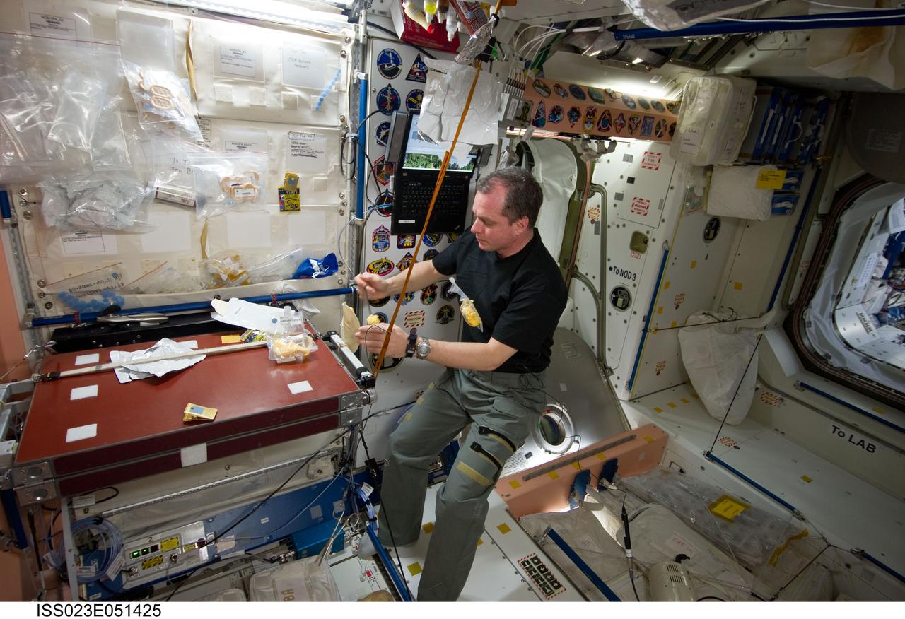 ISS023-E-051425 (25 May 2010) --- NASA astronaut T.J. Creamer, Expedition 23 flight engineer, eats a snack at the galley in the Unity node of the International Space Station.