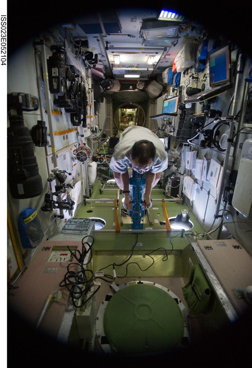 ISS023-E-052104 (26 May 2010) --- Japan Aerospace Exploration Agency (JAXA) astronaut Soichi Noguchi, Expedition 23 flight engineer, uses the IM mass measurement device to perform the PZEh-MO-8/Body Mass Measurement Russian biomedical routine assessments in the Zvezda Service Module of the International Space Station.