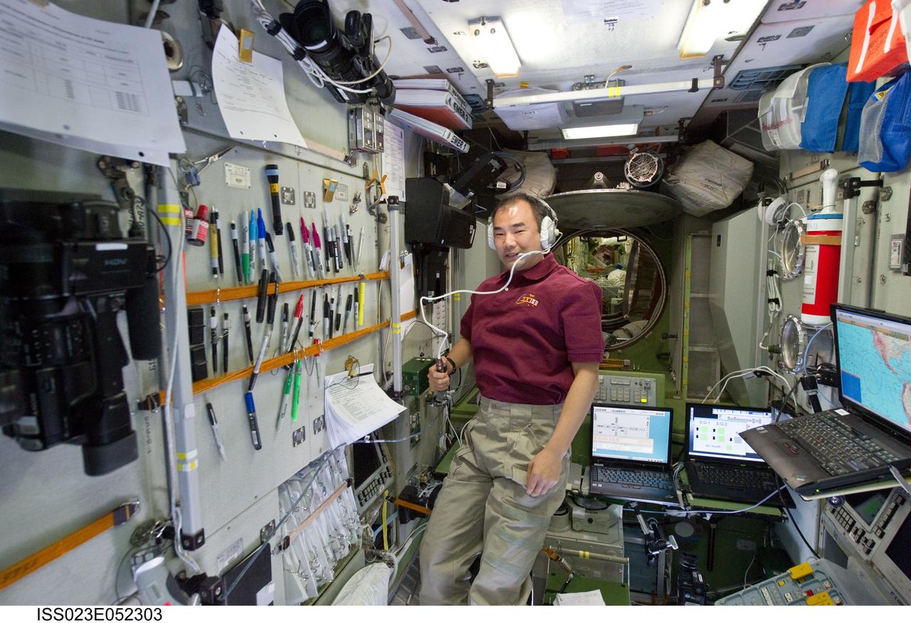 ISS023-E-052303 (26 May 2010) --- Japan Aerospace Exploration Agency (JAXA) astronaut Soichi Noguchi, Expedition 23 flight engineer, uses a communication system in the Zvezda Service Module of the International Space Station.