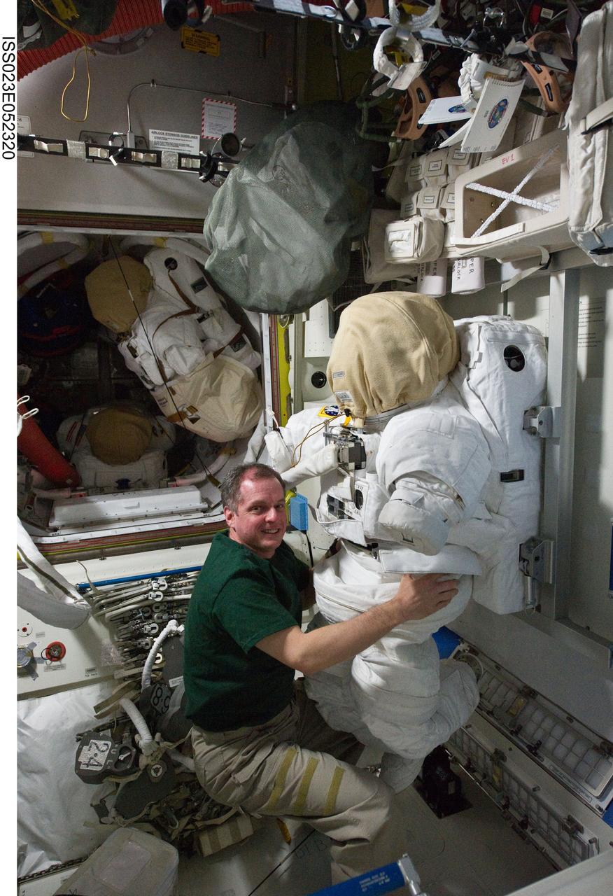 ISS023-E-052320 (26 May 2010) --- NASA astronaut T.J. Creamer, Expedition 23 flight engineer, works with an Extravehicular Mobility Unit (EMU) spacesuit in the Quest airlock of the International Space Station.