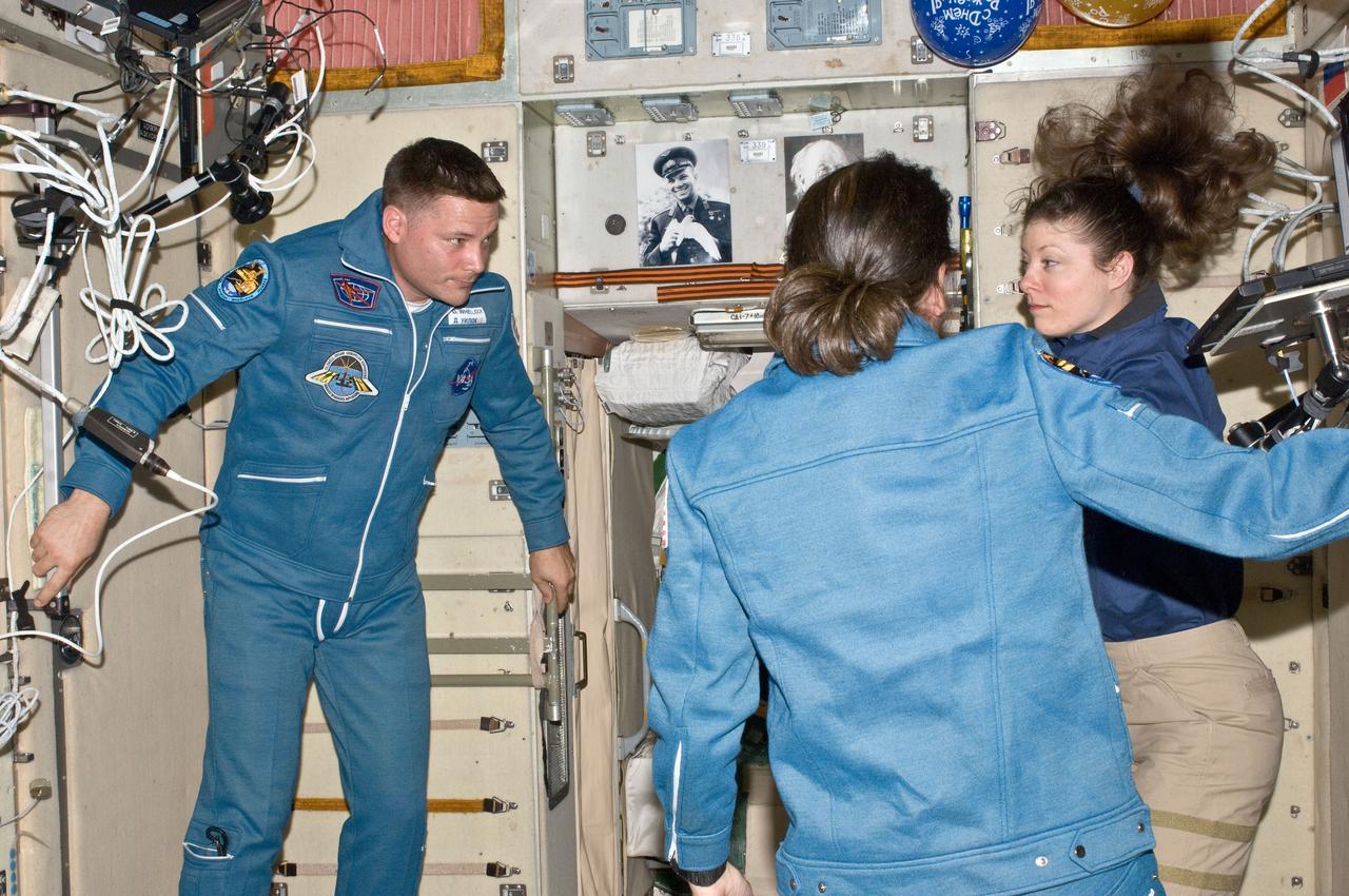 ISS024-E-006194 (17 June 2010) --- NASA astronauts Doug Wheelock, Shannon Walker (foreground) and Tracy Caldwell Dyson, all Expedition 24 flight engineers, are pictured in the Zvezda Service Module of the International Space Station shortly after Wheelock and Walker’s arrival in the Soyuz TMA-19 spacecraft.