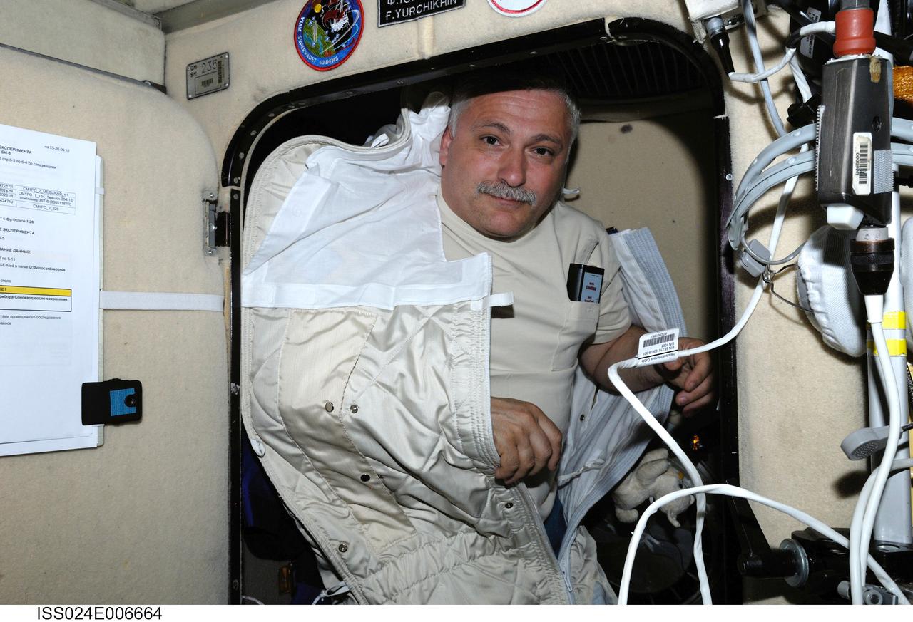 ISS024-E-006664 (25 June 2010) --- With most of his body tucked away in a sleeping bag, Russian cosmonaut Fyodor Yurchikhin, Expedition 24 flight engineer, is pictured in his crew quarters compartment in the Zvezda Service Module of the International Space Station.