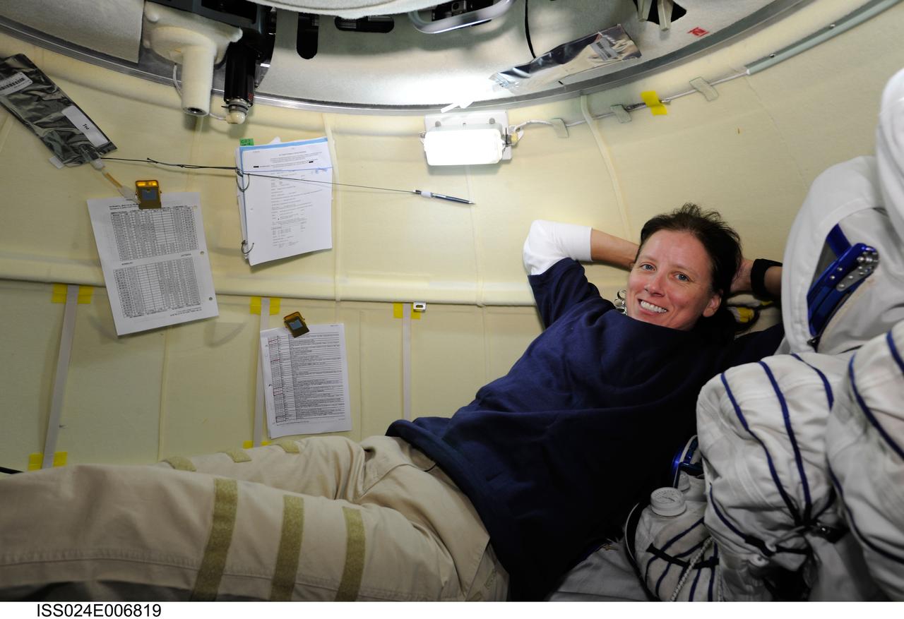 ISS024-E-006819 (28 June 2010) --- NASA astronaut Shannon Walker, Expedition 24 flight engineer, is pictured in the orbital module of the Soyuz TMA-19 spacecraft while docked to the Zvezda Service Module’s aft port of the International Space Station. Later Walker, along with NASA astronaut Doug Wheelock and Russian cosmonaut Fyodor Yurchikhin donned their Russian Sokol launch and entry suits and relocated the Soyuz from the Zvezda aft end to the Rassvet Mini-Research Module 1 (MRM1).