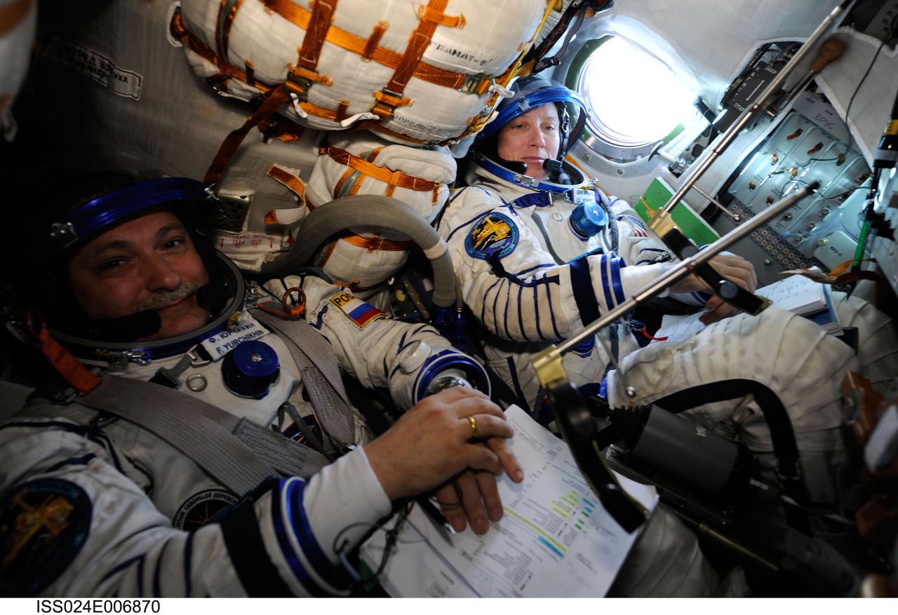 ISS024-E-006870 (28 June 2010) --- Russian cosmonaut Fyodor Yurchikhin and NASA astronaut Shannon Walker, both Expedition 24 flight engineers, attired in their Russian Sokol launch and entry suits, occupy their seats in the Soyuz TMA-19 spacecraft docked to the International Space Station. Yurchikhin and Walker, along with NASA astronaut Doug Wheelock (out of frame) were about to relocate the Soyuz from the Zvezda Service Module’s aft port to the Rassvet Mini-Research Module 1 (MRM1).